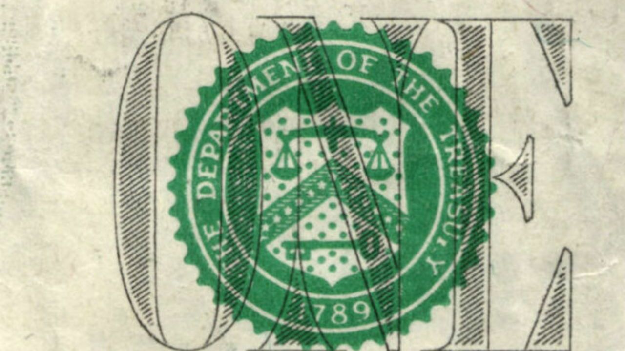 Герб Минфина США на однодолларовой купюре.